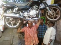 13963-man_balance_carry_motorcycle_head.jpg