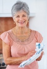 6472575-portrait-of-a-happy-and-pretty-senior-lady-wiping-a-plate-at-the-kitchen.jpg